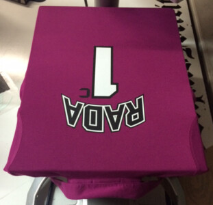 Name and number on the back of a girls polo tee. Team lettering back of shirt